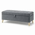 Banc de rangement en velours gris avec pieds en métal doré